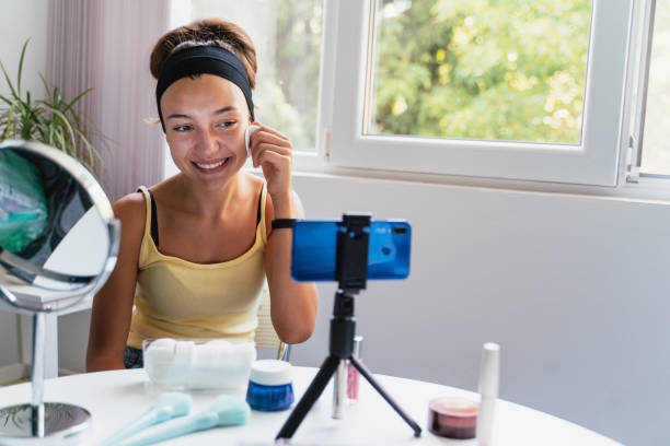 istock Young vlogger conducting a skincare video demonstration. 2186498441