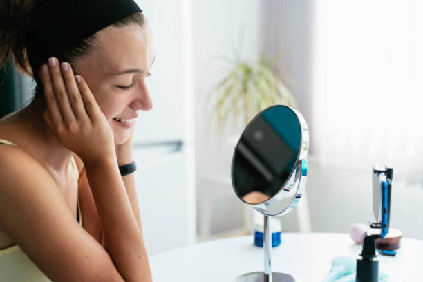 istock Joyful woman checks makeup results in mirror setup. 2186498498