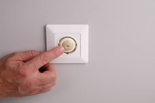 istock A hand installs a protective plug into an electrical outlet to protect children from electric shock. 2186506769