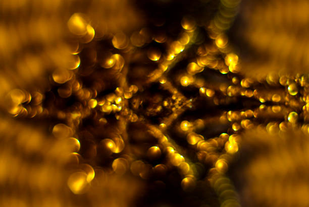 Background. A blurry gold and black image with lots of circles. The image has a dreamlike and ethereal quality. Luxury. Christmas. New Year.