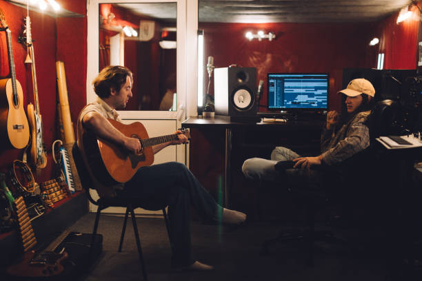 istock Musician preparing a song while producer listens 2186509291