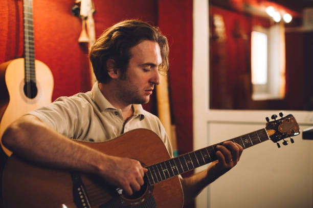 istock Acoustic guitarist enjoying a creative session in the studio 2186509344