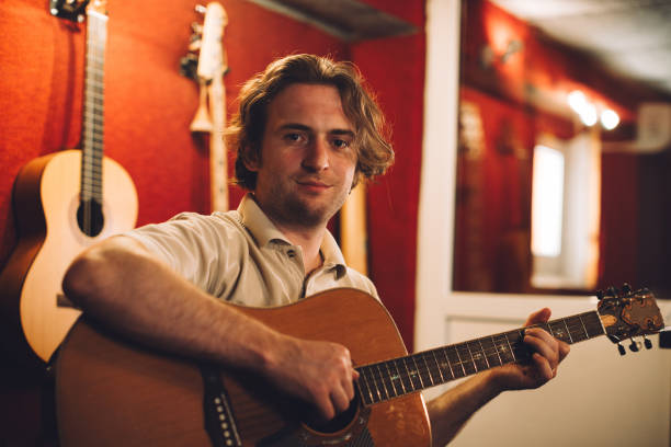 istock Acoustic guitarist enjoying a creative session in the studio 2186509348