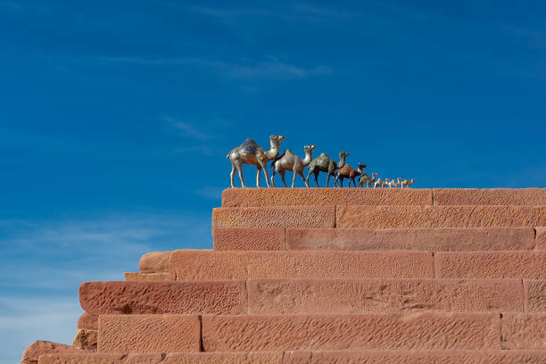iron souvenir camels on red stone steps