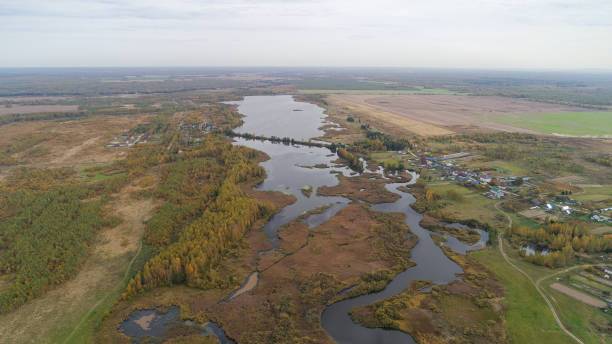 istock Large body of water is surrounded by trees and grass 2186512604