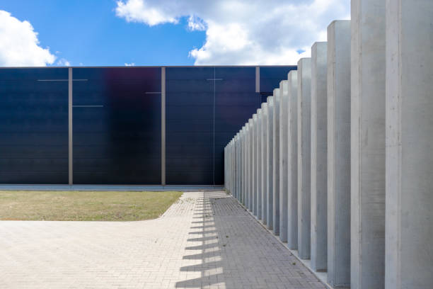 istock .industrial concrete building wall with pavement and mowed lawn 2186512883