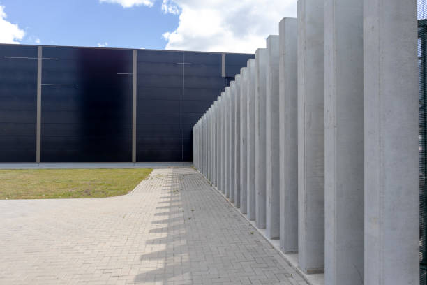 istock .industrial concrete building wall with pavement and mowed lawn 2186512891