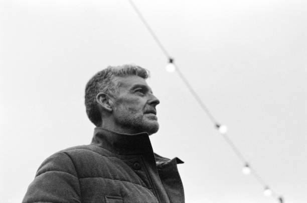 istock Grey-haired mature man looking up in black and white analog photo 2186513651