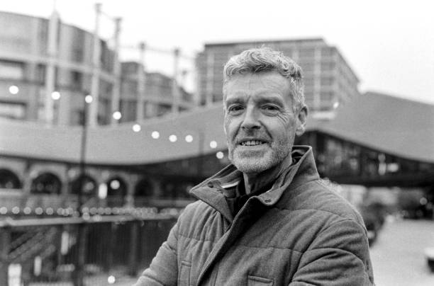 istock Smiling senior man posing in urban setting, grainy analog effect 2186513655