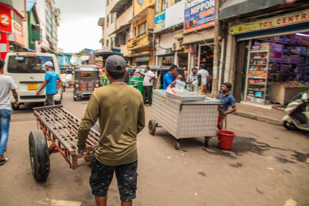 Colombo, Sri-Lanka. 03. 02. 2023. Crowded street of Pettah central Market in Colombo. people sell things and food directly from street on small trays or directly from ground. Traditional