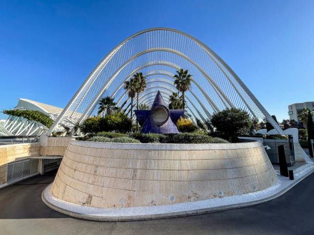 Valencia, Spain. Tuesday the 19th of November 2024: A zoomed in view of the Museu de les Ciències and surrounding structures in the City of Arts and Sciences, showcasing the futuristic architectural design by Santiago Calatrava. The clear blue sky and reflective water add to the serene atmosphere of this iconic cultural landmark.