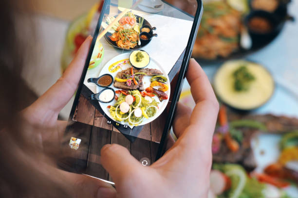 istock A person capturing a food plate with a smartphone, showcasing vi 2186521873