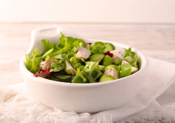 Green salad with edamame and chicken in a bowl