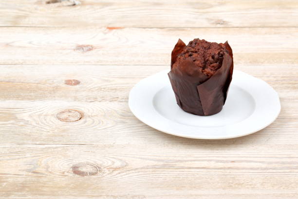 istock Indulge in a Decadent Chocolate Muffin, attractively showcased on a Rustic Plate for presentation 2186529375