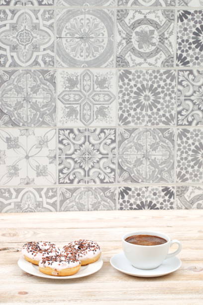Savoring Coffee and Donuts on a Beautiful Vintage Tile Background with Elegant Ambiance