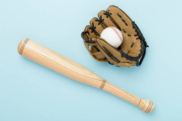 istock Baseball glove and bat with ball on color background, top view 2186530755