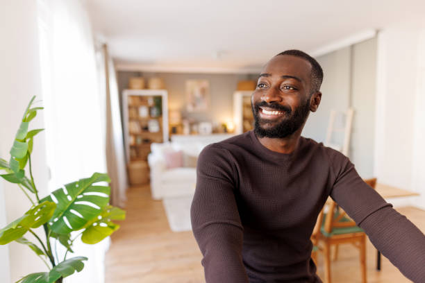 istock Man enjoying moment indoors with vibrant stylish decor. 2186531917