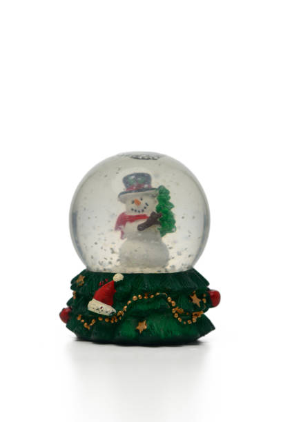 istock Magic snow globe featuring a cheerful snowman beside a decorated Christmas tree during winter festivities 2186532149