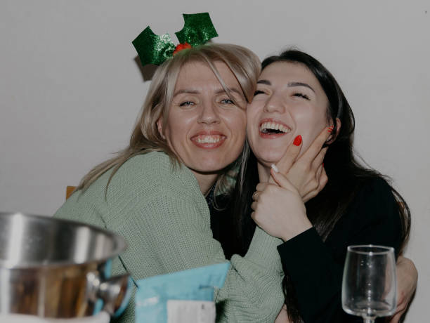 istock Two happy and laughing girls at the table. 2186534445
