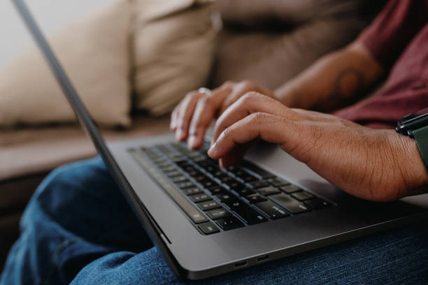 istock Closeup of hands typing on laptop on lap 2186535273