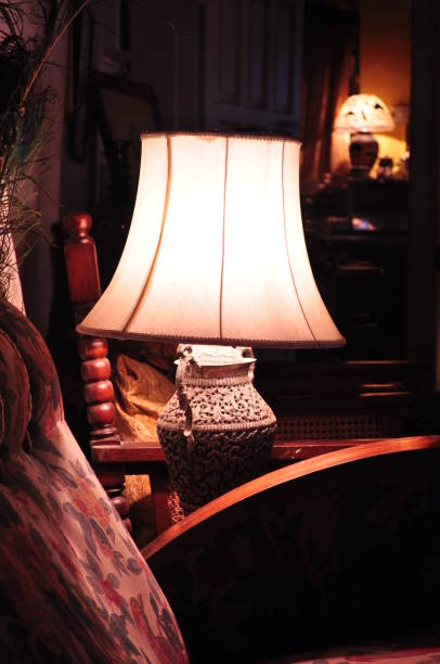 istock An indoor lamp lit up on a side table besides a couch 2186541497