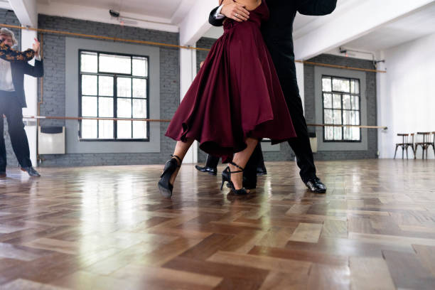 Close-up of legs of dancers dancing tango in a dance studio