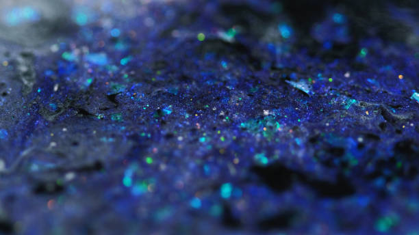 istock Liquid glitter spill shimmering fluid purple black 2186542573