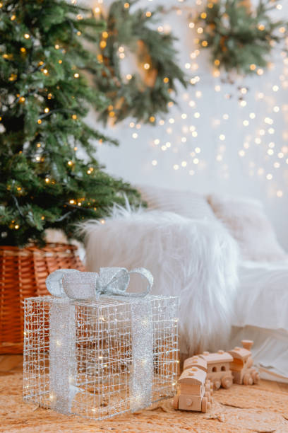 istock Decorated Christmas tree with gift box and cozy decor in festive setting 2186543874