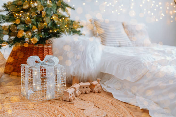 istock Cozy holiday setup with a decorated tree and wrapped gift in soft lighting 2186543875