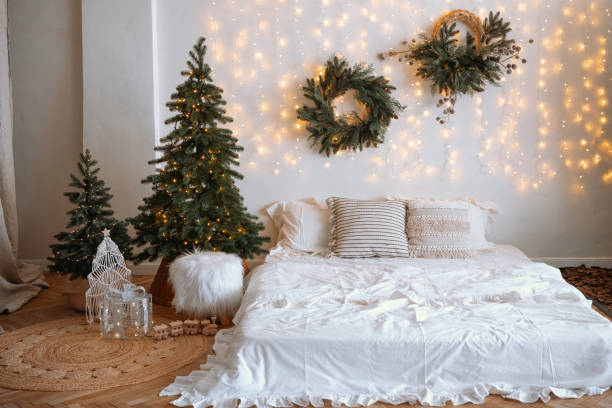 istock Cozy winter bedroom decor with Christmas trees and warm lighting 2186543884