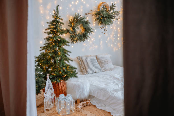istock Cozy, festive bedroom adorned with holiday lights and greenery 2186543887