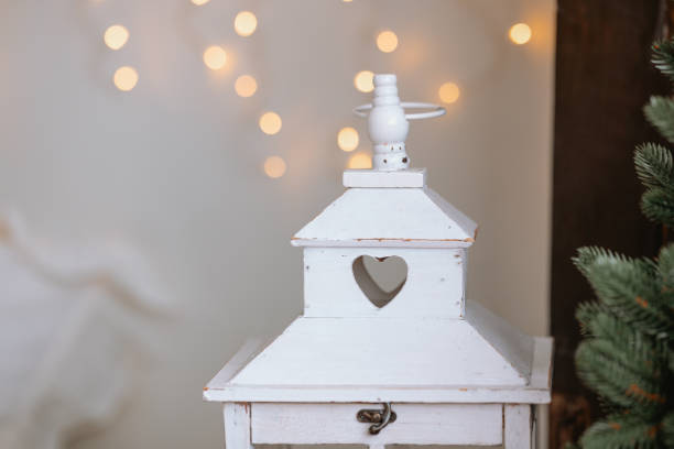 istock Decorative white lantern with a heart shape and blurred fairy lights backdrop 2186543907