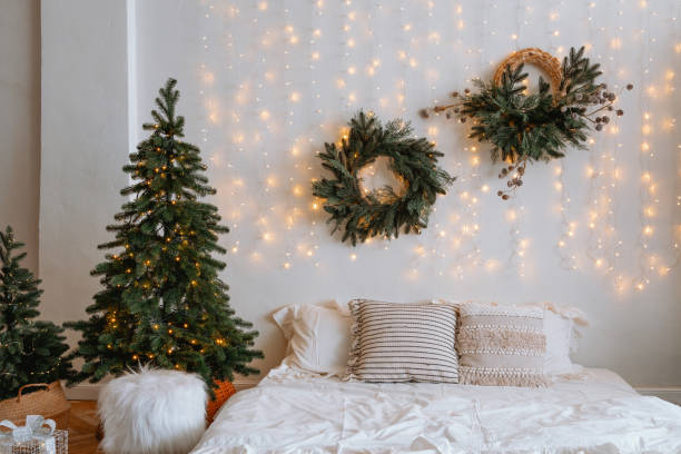 istock Cozy bedroom with Christmas tree and festive decorations in warm lights 2186543909