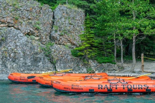 Banff, Alberta, Canada â July 21, 2024: Inflatable boats ready for white water raft tours on the Bow River in Banff National Park