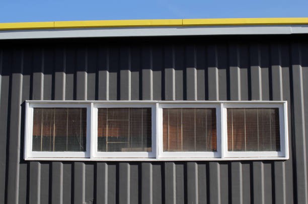 istock Building with a dark exterior wall, glass windows and a yellow roof 2186547638