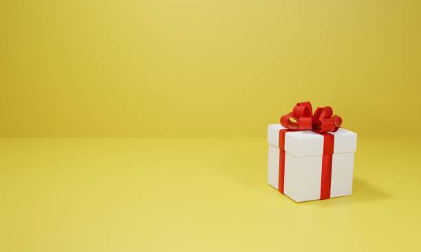 istock Yellow background Cute little gift box with red ribbon 2186550962
