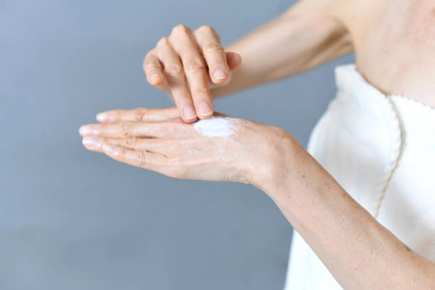 istock Image of a middle-aged woman applying cream to her hands 2186552615
