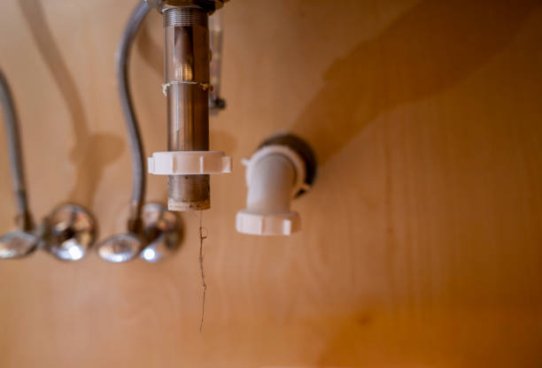 selective focus on a bathroom sink drain disconnected with a hair clog hanging down. High quality photo