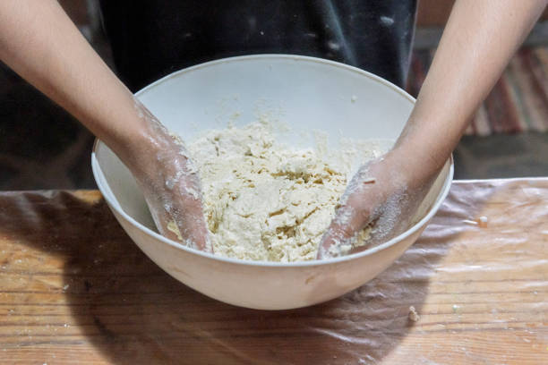 Detail of hands preparing dough