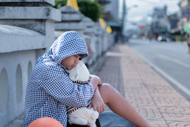 Indonesia,Solo - June 6,2024 : beggar woman sitting on the side of the road asking for money as people pass by