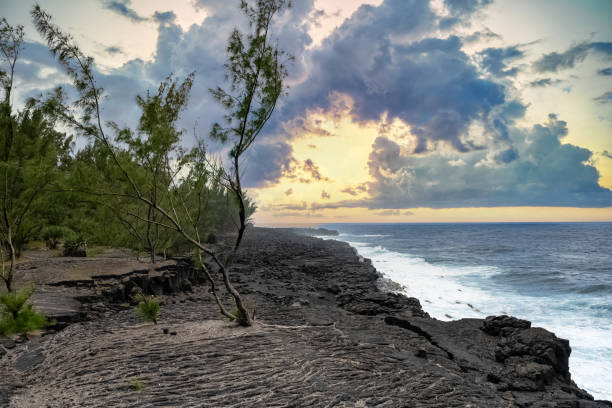 Dramatic scenes of ocean waves crashing against rocky cliffs on Nusa Penida, Indonesia, under a bright blue sky with scattered white clouds, creating a breathtaking seascape perfect for travel inspiration and coastal landscapes enthusiasts.