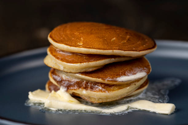 istock thin hot pancakes with butter on a blue plate 2186564682
