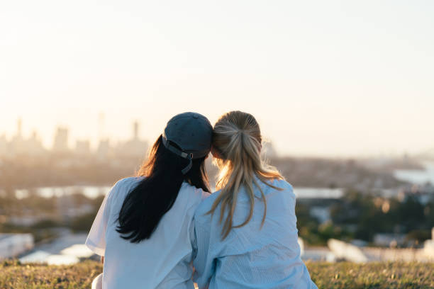 istock Friends sharing a quiet moment at sunset overlooking the horizon 2186565552