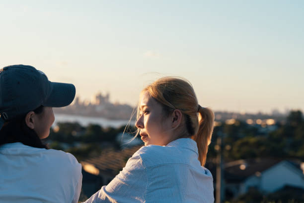 istock Two women sharing a moment of connection under the evening sun. 2186565570