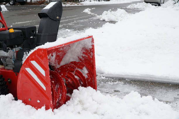 istock snow blower blowing snow away from driveway 2186569826