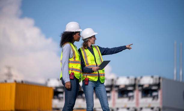 istock Engineer or worker team are standing forklift or truck vehicle are working appear discussing or reviewing document, likely related inspect container factory and industry transportation import export. 2186571691