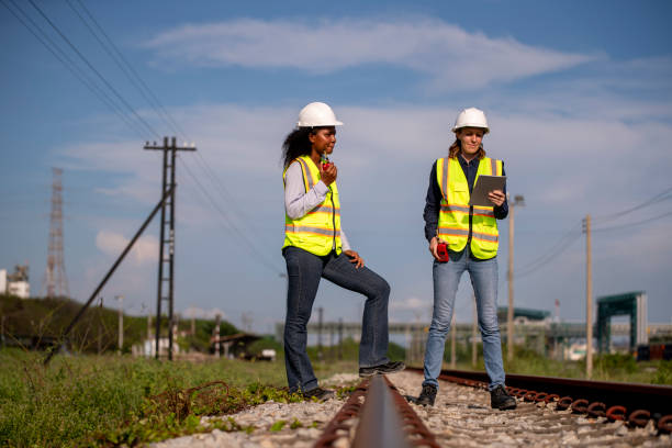 istock Engineer railway engaged in discussion or inspection maintenance work greenery and gas or oil power industrial or transportation setting in the rail train import export logistics industry concept. 2186571729