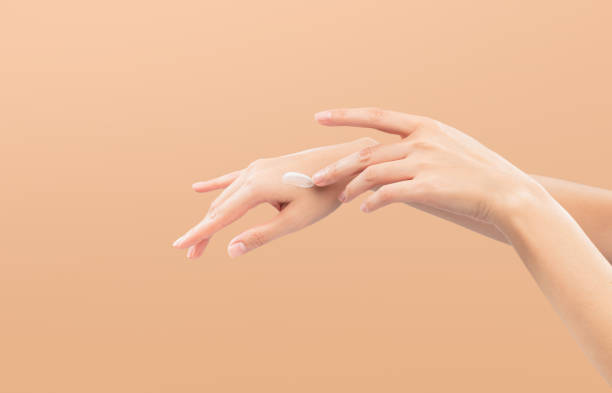 istock Woman hand applying cosmetic cream on her finger on background. 2186571913