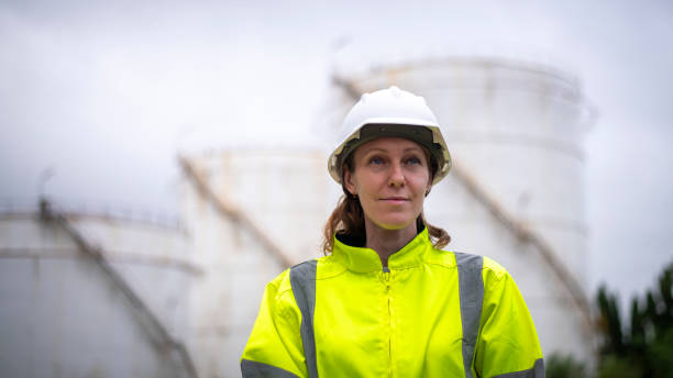 istock Engineers wearing safety gear, including hard hats examining survey a large blueprint tablet standing industrial facility gas or oil refinery engaged in a job requires high safety standards concept 2186572017
