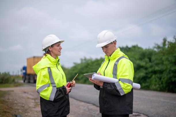 istock Engineer or worker working in the construction container yard discussing or reviewing detail on tablet likely related to inspect about factory container shipping Logistics business concept. 2186572068